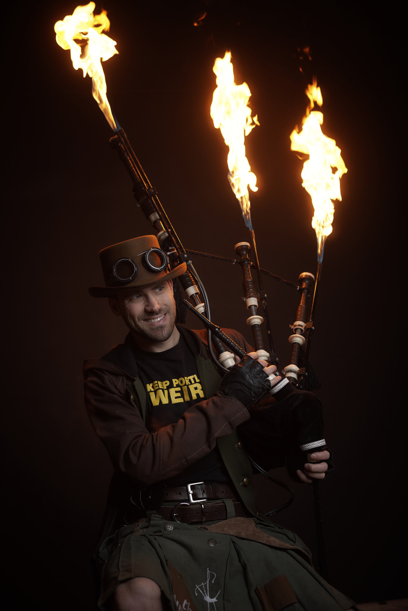 The Unipiper, Brian Kidd, with flaming bagpipes